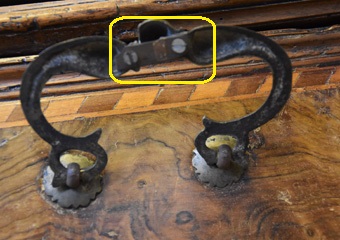 Cassettone intarsiato XVII° sec., area lombarda. Prima del restauro, particolare del dietro della maniglia danneggiata.